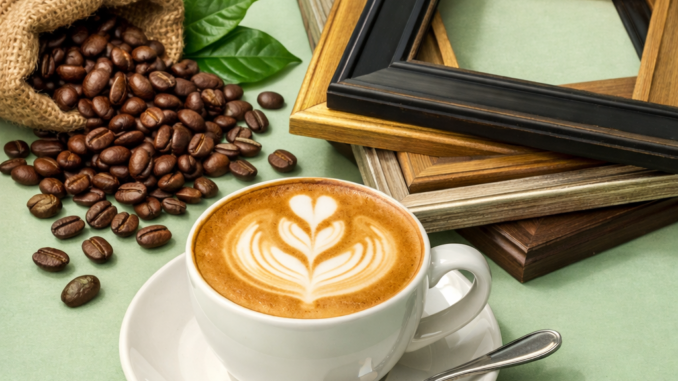 Generic image of a cappuccino, some picture frames, and coffee beans.