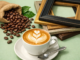 Generic image of a cappuccino, some picture frames, and coffee beans.